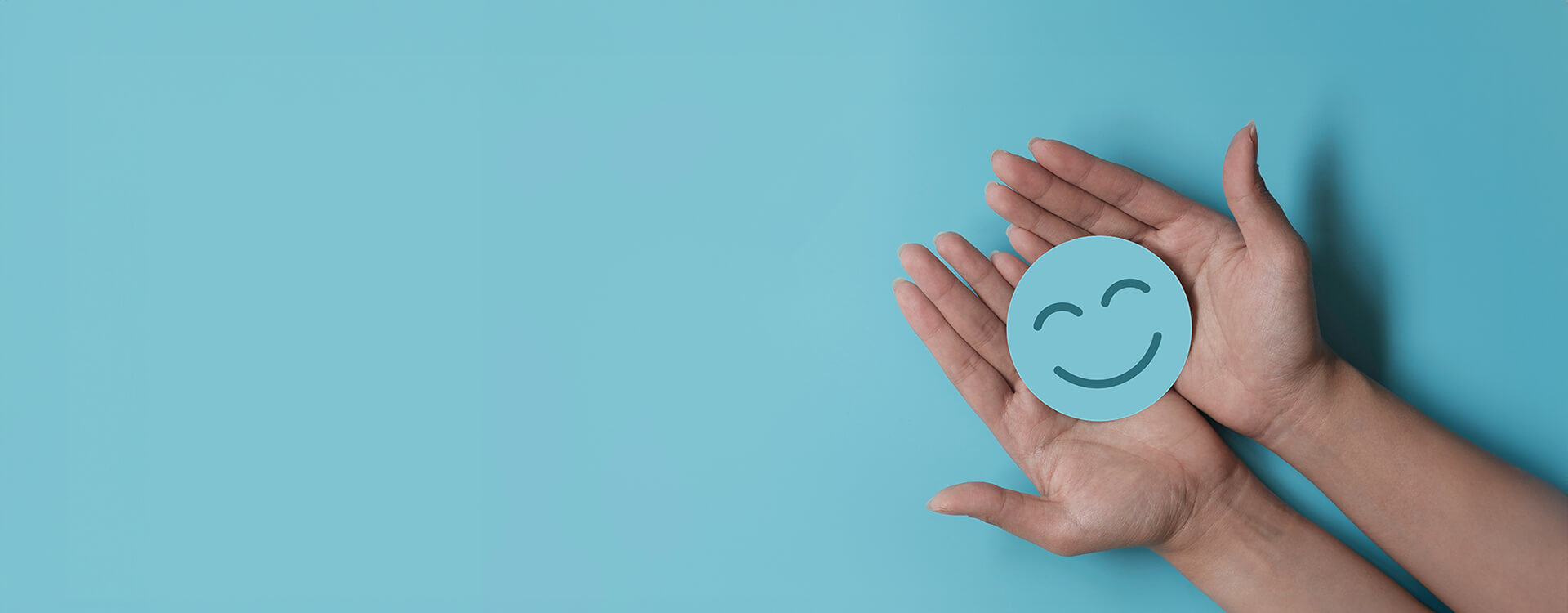 Hand holding blue paper cut happy smile face, Positive thinking, Mental health assessment , World mental health day concept